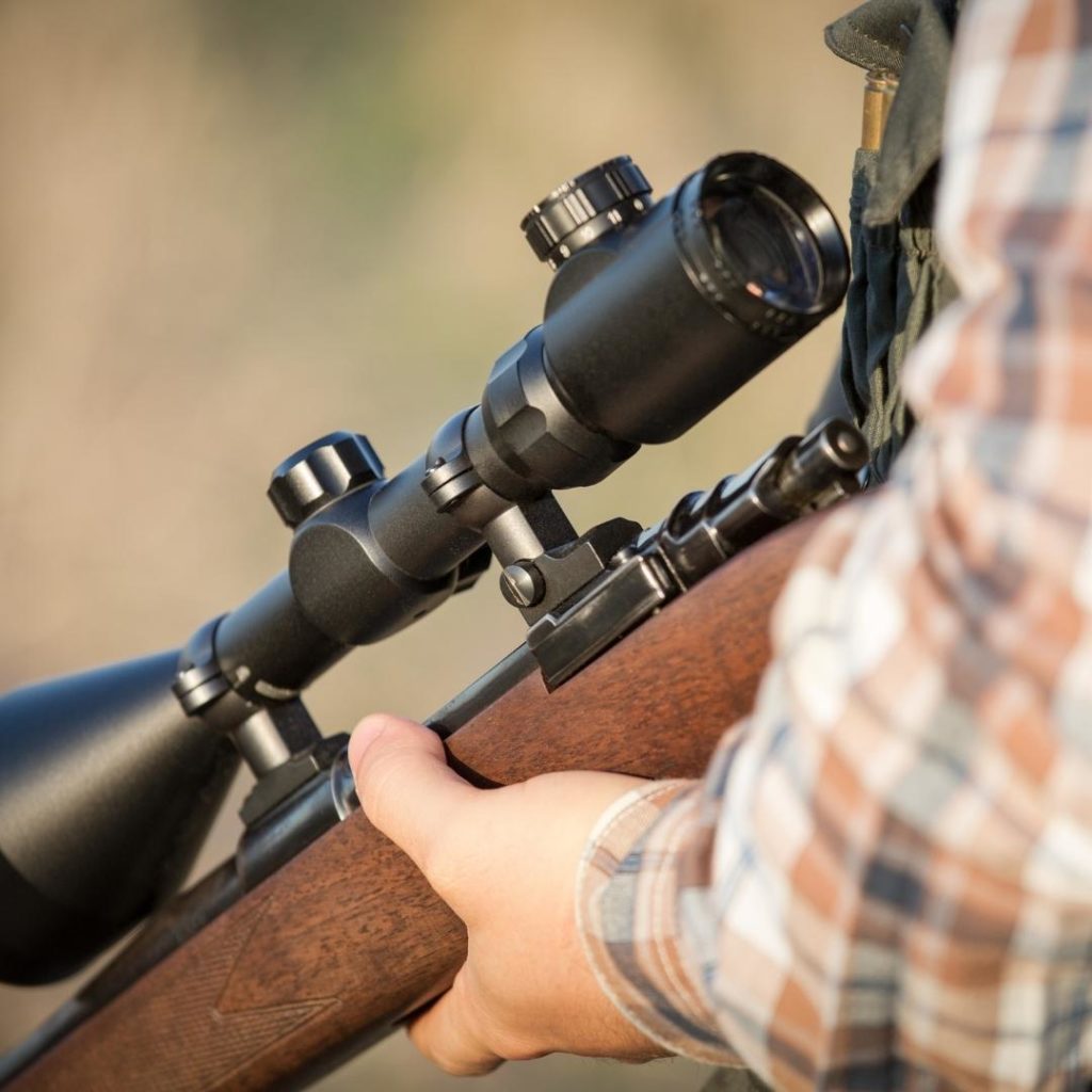 Close up of a hunter holding a gun